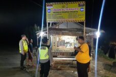 Petugas Kepolisian Polsek Bantur saat memasang banner dan rambu-rambu penunjuk arah di jalan menuju kawasan pantai di Malang Selatan (28/5/2025) (Dok. Humas Polres Malang)